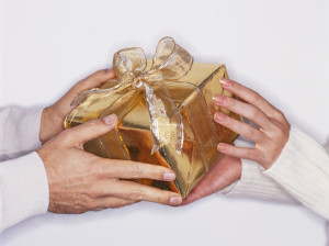 Hands Exchanging Wrapped Gift